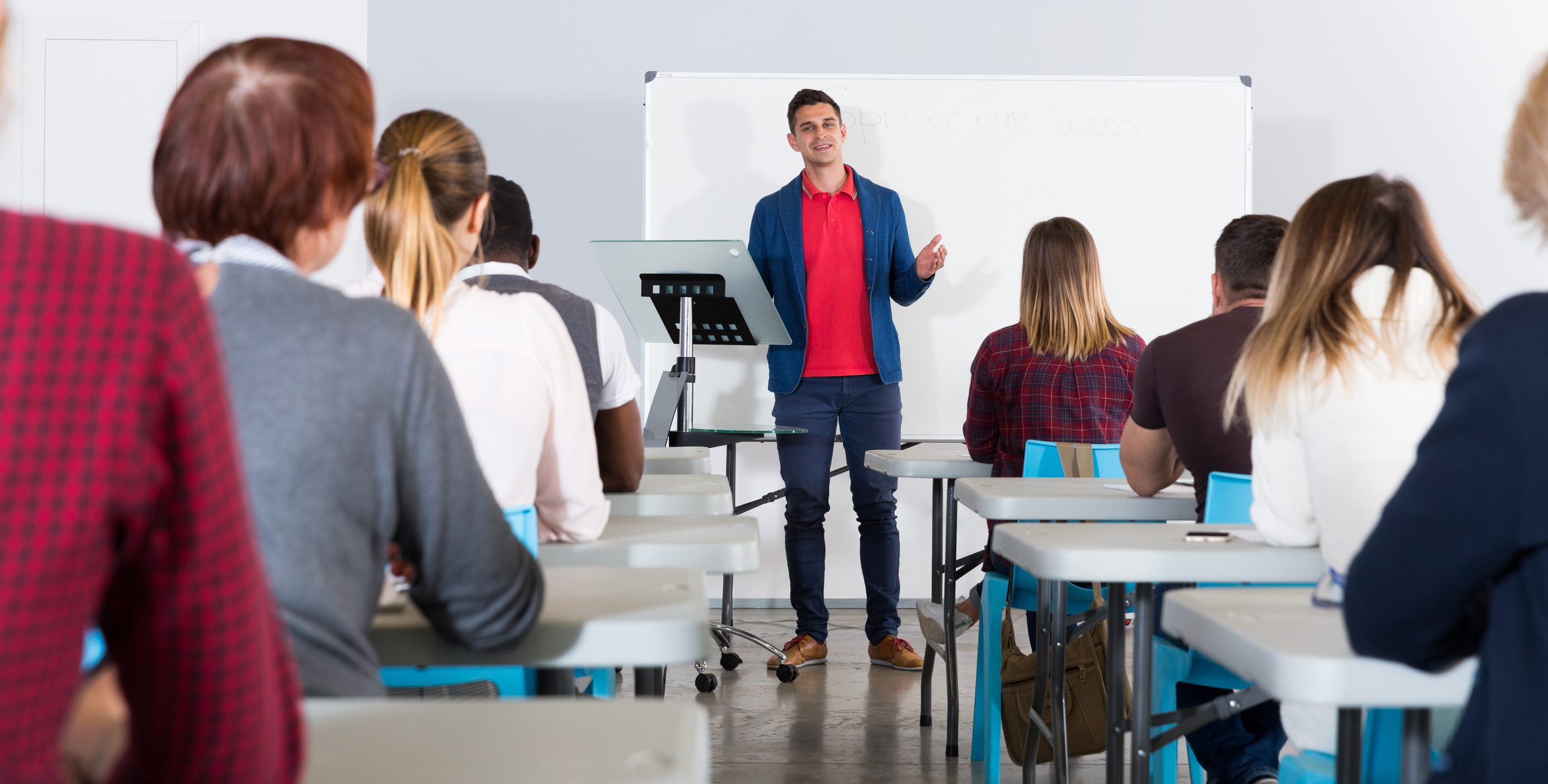 Male teacher giving presentation for students